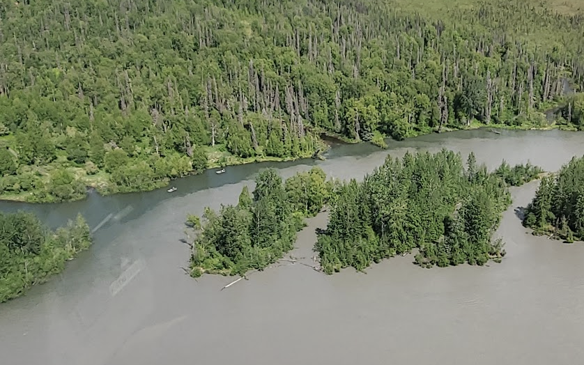 Boat on Alaska river at sunset
