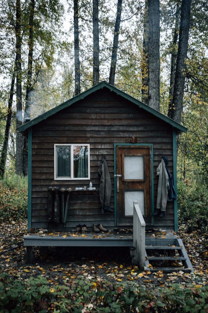 Fishing gear hanging inside a cozy cabin at Lake Creek Lodge in Alaska